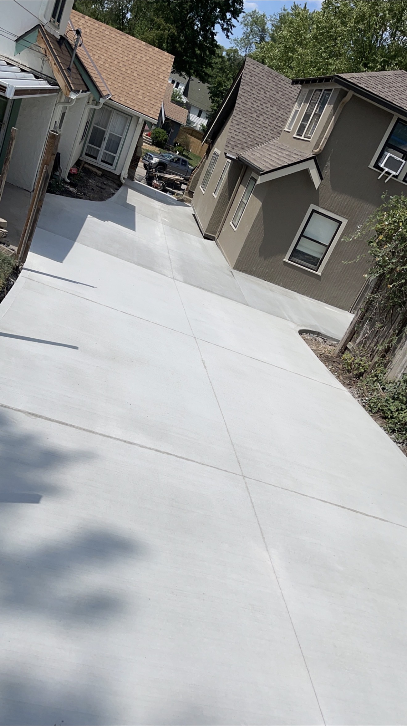 Finished shared concrete driveway running between two houses